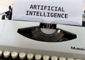 A close-up of a typewriter showcasing 'ARTIFICIAL INTELLIGENCE' on paper.